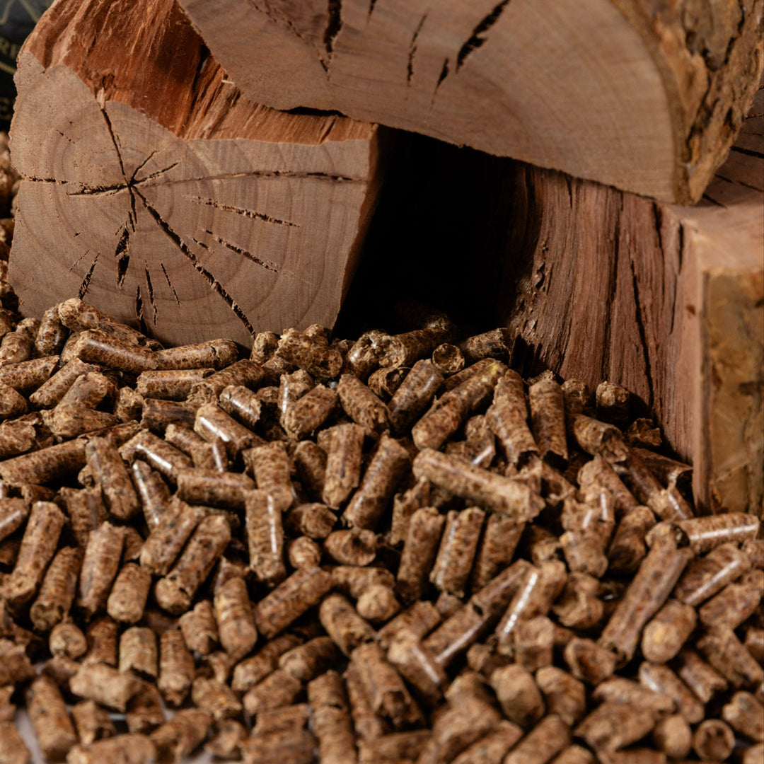 Cutting Edge Firewood pellets on a wooden block with a log in the background