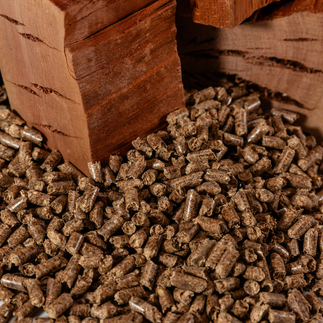 Cutting Edge Firewood pellets on a wooden block with a log in the background