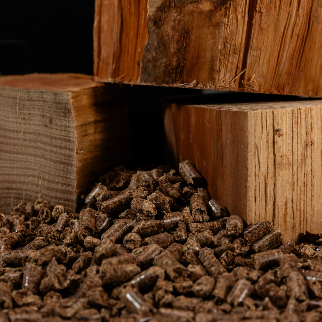 Cutting Edge Firewood pellets on a wooden block with a log in the background